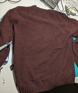 A dark red jumper with chunky knit