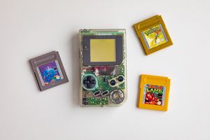 A clear gameboy and 3 games with rounded corners